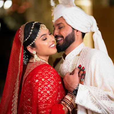 A smile that says it all. This candid close-up captures the groom whispering to his bride, resulting in a moment of pure, unscripted happiness.