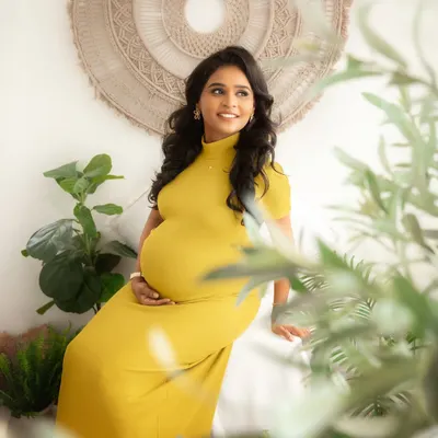 A quiet moment of reflection for this glowing mumma-to-be. The natural light and earthy tones of my boho-chic studio setup create a serene and calming atmosphere for your maternity portraits.