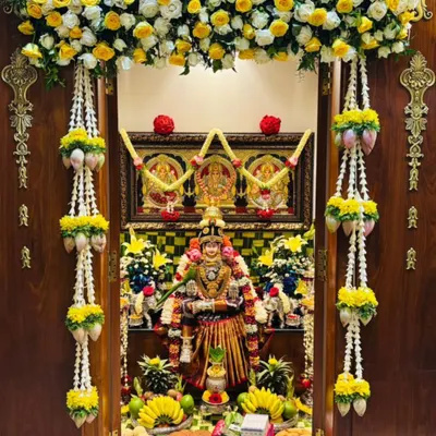 You will learn the art of decorating sacred spaces, like this beautiful pooja room for Varamahalakshmi. We cover everything from floral arrangements and fruit displays to traditional lotus and thomale garlands.