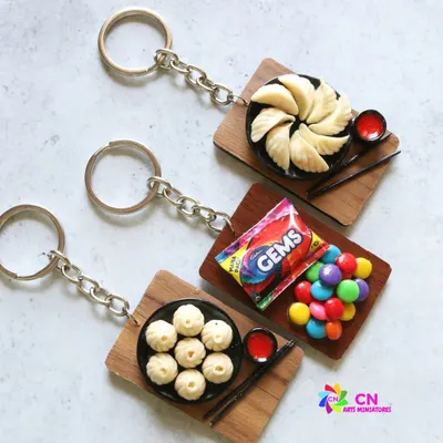 A collection of my food-themed keychains, featuring momos and Gems chocolate.