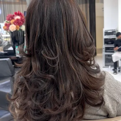 A perfect example of a Coffee Brunette transformation. The deep, rich tones have a beautiful shine, and the layered cut gives the hair wonderful movement and body.