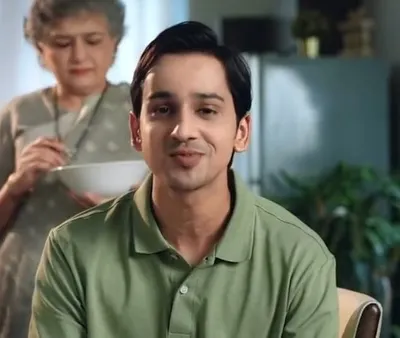 A still from an ad shoot for Cult. The makeup for the actor is clean and natural, ensuring he looks relatable and fresh-faced on camera for this lifestyle scene.