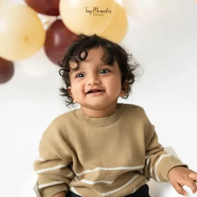 That heart-melting smile. This close-up portrait from a sitter session captures the pure joy and personality of this handsome little boy.