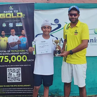 Presenting the winner's trophy at the TPL Ad In Open for Boys and Girls Under 12. This 'Race to Gold' event gives young players a shot at a valuable scholarship.