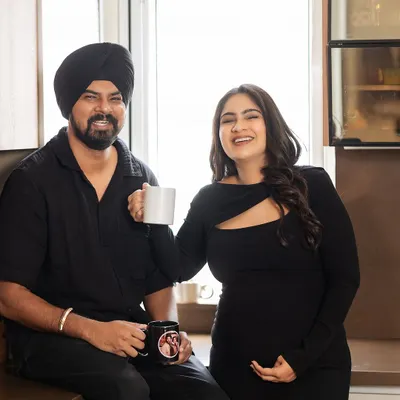 The simple joy of sharing a morning coffee. This candid shot in the kitchen captures a real, happy moment between the couple, showing that the most beautiful memories are often made in the most ordinary moments.