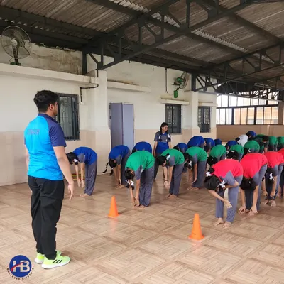 In celebration of International Yoga Day, our coach leads students through a series of stretches. We teach yoga as a path to physical fitness and mental calm.