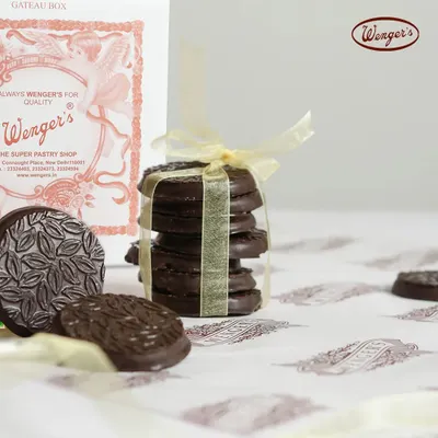 A simple pleasure. Our classic biscuits are made even better with a generous coating of rich dark chocolate, featuring a beautiful embossed pattern. They are stacked and tied with a ribbon, ready for you.