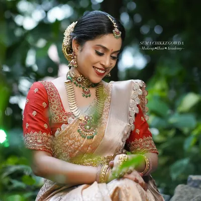 A candid moment from our demonstration shoot, showcasing the complete South Indian bridal look. The makeup remains flawless even in natural outdoor lighting, a testament to the techniques I teach for a long-lasting, radiant finish.