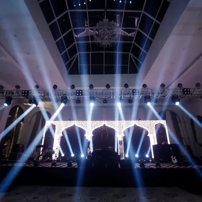 The stage is set. I love capturing the grandeur of the decor before the party begins, highlighting the dramatic lighting and intricate design that creates the event's atmosphere.
