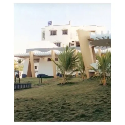 An archival photo of our CC Office project in Tuticorin from 2002. The design deliberately tucked the building to one side of the plot to create a large, manicured landscape, integrating the architecture and its natural surroundings.