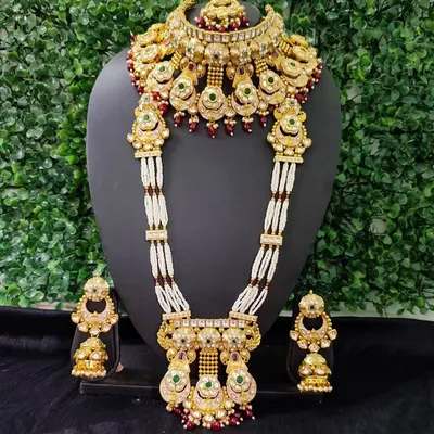 An exquisite polki and kundan bridal set from my for-sale collection, featuring a choker and a long, multi-stranded pearl necklace. The red and green stones add a traditional touch to this regal wedding jewellery piece.