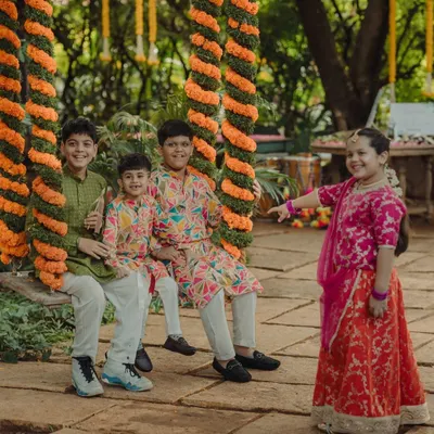 The children having a wonderful time on the floral oonjal. Capturing these moments of pure, simple joy among the younger guests is always a delight.