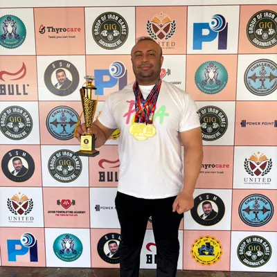 Holding the trophy and medals after winning the overall gold at the Senior National Equipped Powerlifting Championship in Karnataka.
