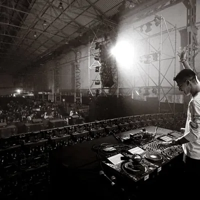 A wide, black and white shot from my performance opening for Talwiinder at Nesco. This shows the immense scale of the warehouse-style venue and the thousands of fans in attendance.