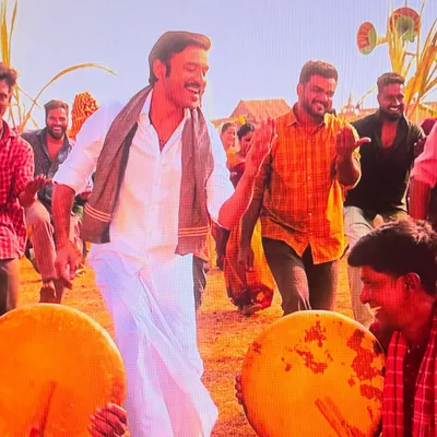 A candid shot from the sets of 'Idly Kadai', sharing a happy moment with Dhanush sir during the shoot of the folk dance song 'Enjaami Thandhaane'.