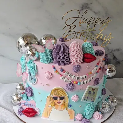 A cake for a true Swiftie. This design is inspired by Taylor Swift's eras, with disco balls, red lips, and other iconic imagery from her albums.