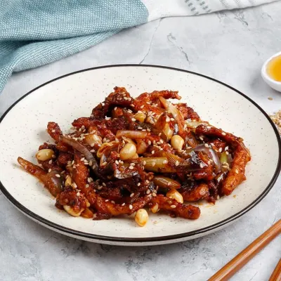 Our Honey Chicken with Peanuts. Crispy chicken pieces are tossed in a sweet honey-based sauce and finished with crunchy peanuts and sesame seeds.