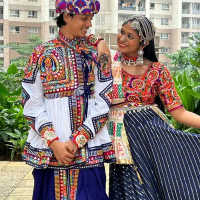 A perfect pair in our coordinated outfits. The man wears a traditionally embroidered kediyu with a colorful pagdi, while the woman's chaniya choli complements his look with similar colors and patchwork details.