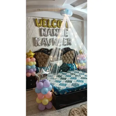 I also do decorations for other happy family occasions. Here is a "Welcome Baby" setup I did, featuring a bed canopy, pastel-colored balloon pillars, and a custom foil balloon banner to welcome the newborn.