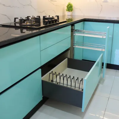 We believe in beauty that is also practical. This image showcases our smart storage solutions, including a multi-tiered pull-out spice rack and a deep drawer with a custom plate organizer, ensuring everything has its place.