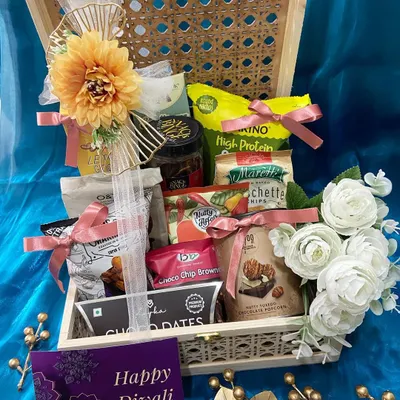 An open view of our cane and wood Diwali hamper, overflowing with high-protein snacks, choco dates, and brownies. It's a perfect blend of healthy and indulgent treats for the festive season.