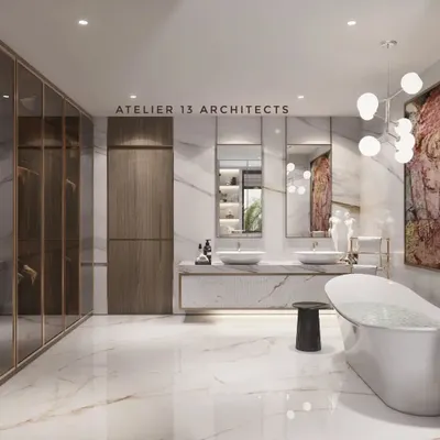 A view of the master bathroom from the opposite angle, showcasing the dual vanity with vessel sinks set on a floating marble counter. The large mirrors reflect the art and light, enhancing the sense of space and opulence.