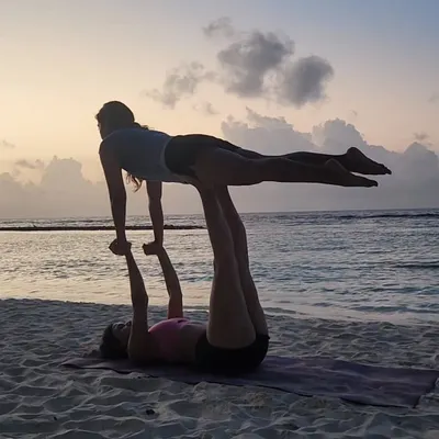 There's nothing like playing with acro yoga as the sun sets over the ocean. It's a practice built on trust, communication, and shared balance, and it always ends in smiles.