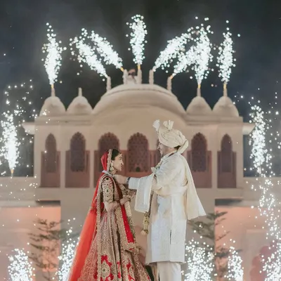 A fairytale moment brought to life against the backdrop of a royal palace, illuminated by a spectacular display of fireworks. We orchestrate these shots to create a truly iconic memory of your union.