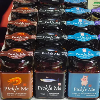 A lineup of our non-vegetarian bestsellers. Featuring our 'Shrimply the Best' Prawn Pickle, classic Tuna Pickle, and the rich 'Porky the Pig' Pork Pickle, all handmade with authentic spices.