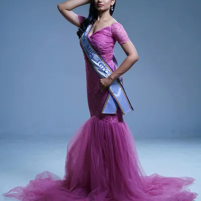 A pageant winner looking regal in my pink off-shoulder mermaid gown. The fitted silhouette and flared tulle bottom create a stunning, award-winning look.