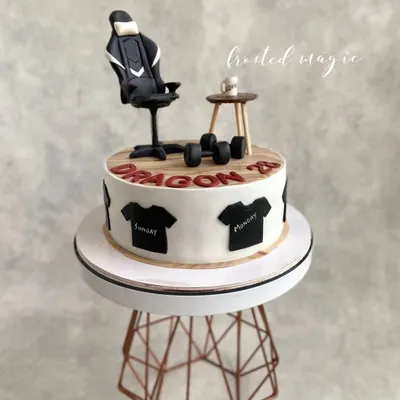 This cake was designed for someone whose favorite things include their gaming chair, coffee, and working out. I recreated these items in miniature form as edible toppers to make a cake that's all about them.