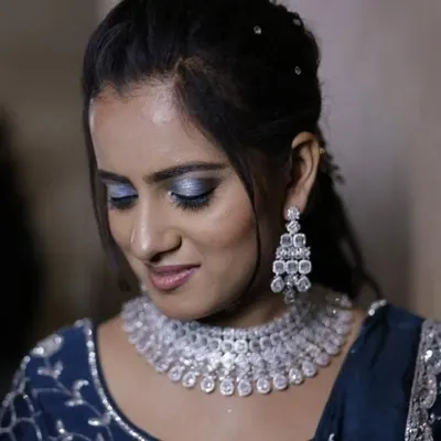 A client looking absolutely glamorous for her sangeet night. She is wearing a dazzling rhodium-polished American Diamond necklace that sparkles with every move.