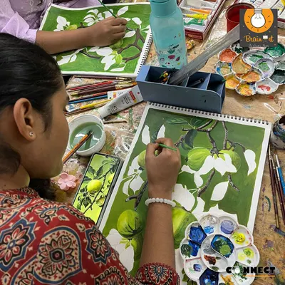 We begin a new project by blocking in the main shapes and colors. This student is using a reference photo to create a realistic composition of fruit on a branch.