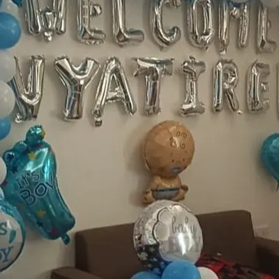 A beautiful welcome home for baby Vyatirek. This wall decoration features silver foil letters spelling out the baby's name, framed by a blue and white balloon arch and accented with 'It's a Boy' themed foils.