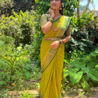 A client looking lovely in a green beaded blouse and lime green saree, perfect for a daytime event.