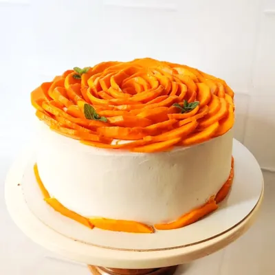 My signature creation, the Alphonso Mango Rose Cake. I meticulously arrange fresh, seasonal mango slices to form an intricate rose. This cake is a testament to my belief that natural ingredients can be the most beautiful decoration.