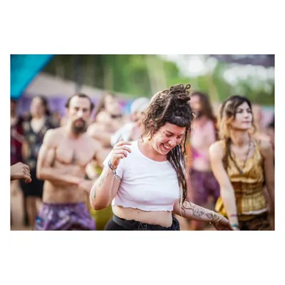 The pure, uninhibited joy of dancing. This candid shot from a music festival captures a moment of complete freedom and happiness.