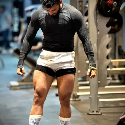 Strong legs are the pillars of a strong body. This pose shows the result of consistent, heavy leg days, building both size and definition in the quads.