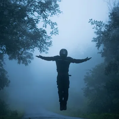 A creative shot of me appearing to levitate on a foggy road, surrounded by mist-covered trees. This image captures the feeling of freedom and breaking away from the mundane that my monsoon rides represent.