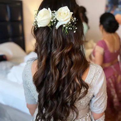 Floral hairstyles are always on trend. This beautiful, soft wavy look with fresh roses was created for a bridesmaid, showcasing our skills in both makeup and hair.
