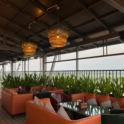 A comfortable lounge area at 'The Soda Factory' pub, where we used rows of tall, leafy plants to create natural partitions between seating zones. This adds a sense of intimacy and brings a soft, organic element to the decor.