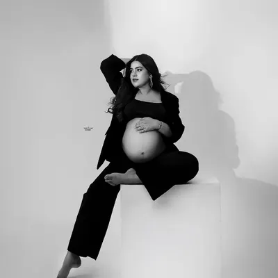 Mamma acing the game of light. This modern, high-fashion black and white portrait showcases a powerful pose and beautiful lighting.