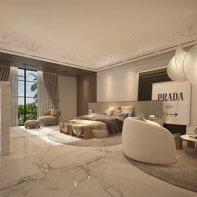 This expansive master suite features polished marble floors and a soft, neutral color palette. We designed a custom room divider to create a separate study nook, and curated the space with unique pendant lights and Prada wall art.
