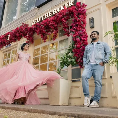 A fairytale moment in the city, with the bride's pink gown creating a beautiful, flowing silhouette. I love finding unique urban backdrops for pre-wedding couple photography.