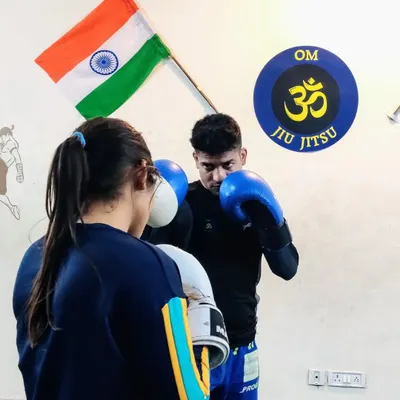 Focusing on the basics during a boxing drill. No matter how advanced you get, solid fundamentals are the key to effective striking. Here, I'm working with a student on her guard and punch delivery.