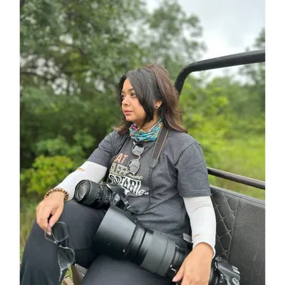 Me on safari, ready for action with my cameras. I call them my bazookas! This is my happy place, out in the wild, ready to capture a story.