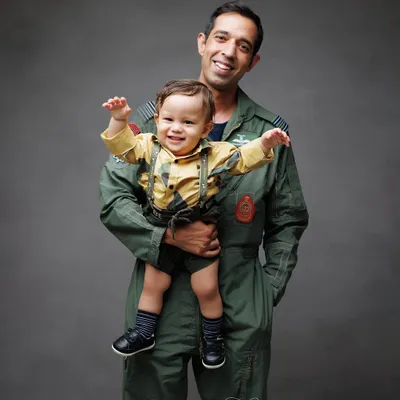A father's love and joy are palpable as he holds his son. This portrait of the Airforce dad and his little boy is full of happiness and pride.