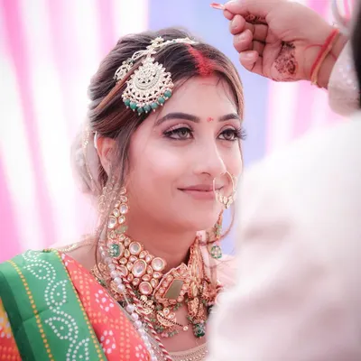 The sindoor ceremony is one of the most significant moments in a Hindu wedding. I focused on the bride's serene expression as the sindoor is applied, capturing the emotion and sanctity of this beautiful ritual.