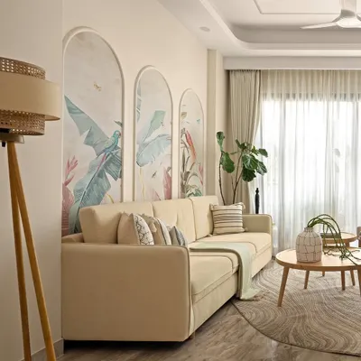 This living room was designed to feel like a sanctuary, wrapped in softness and calm. The arched wall panels with hand-painted murals, muted color palette, and gentle curves create a peaceful rhythm that flows through the space.