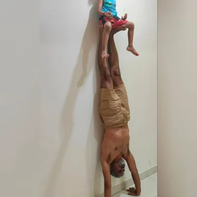 A moment of father-son acro yoga. Balancing my son on my feet during a handstand is a beautiful exercise in trust, strength, and connection. What title would you give this?